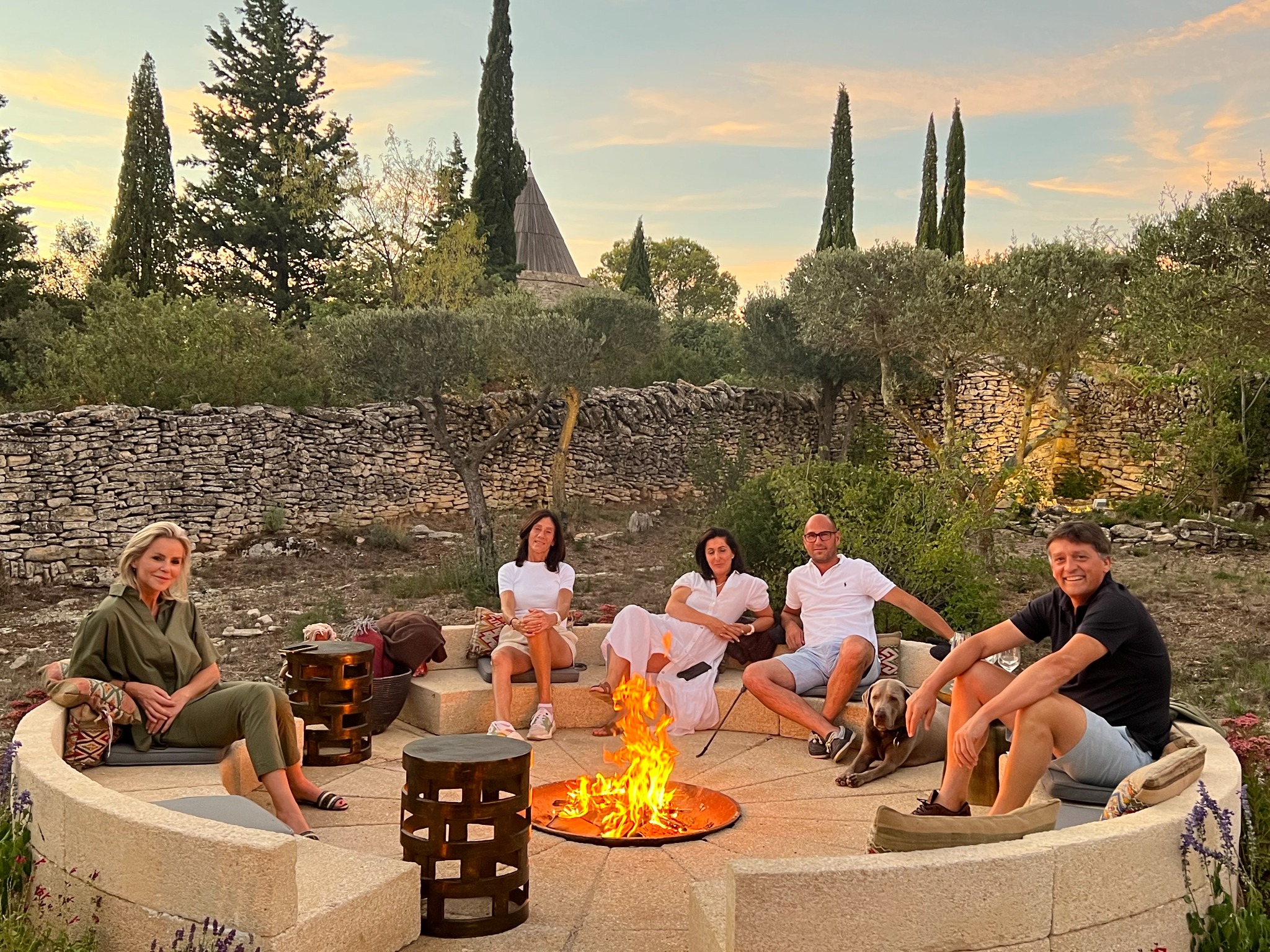 Friends gathered around the brasero at sunset