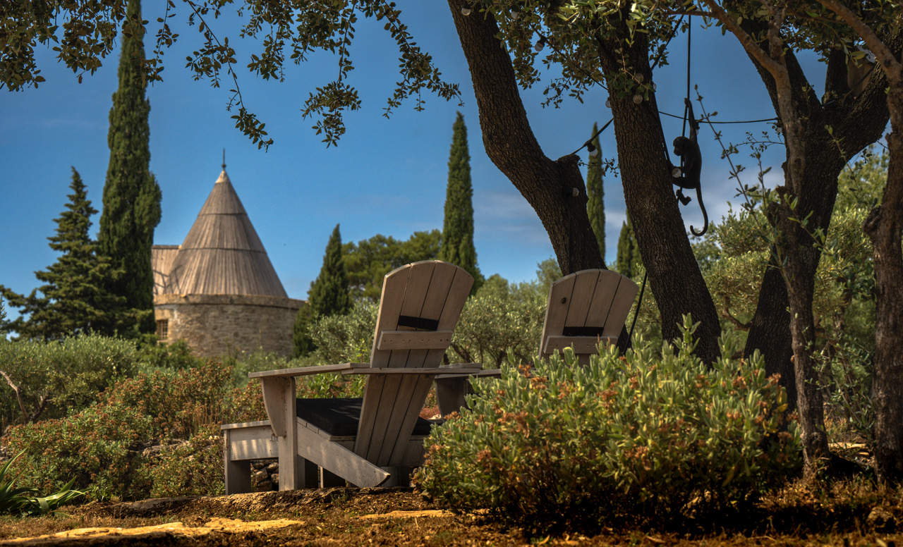 Two chairs overlooking the mill and garrigue