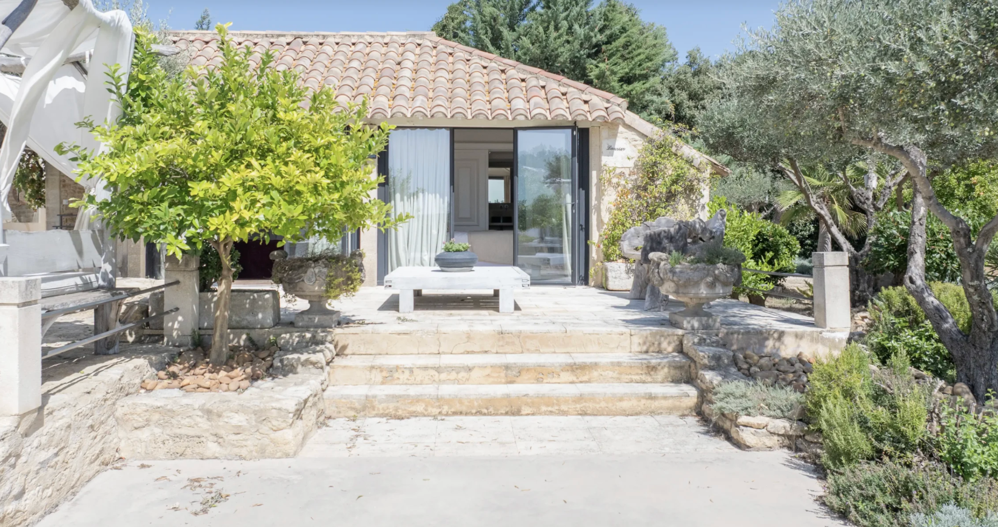 Private room entrance among herbs and olive trees