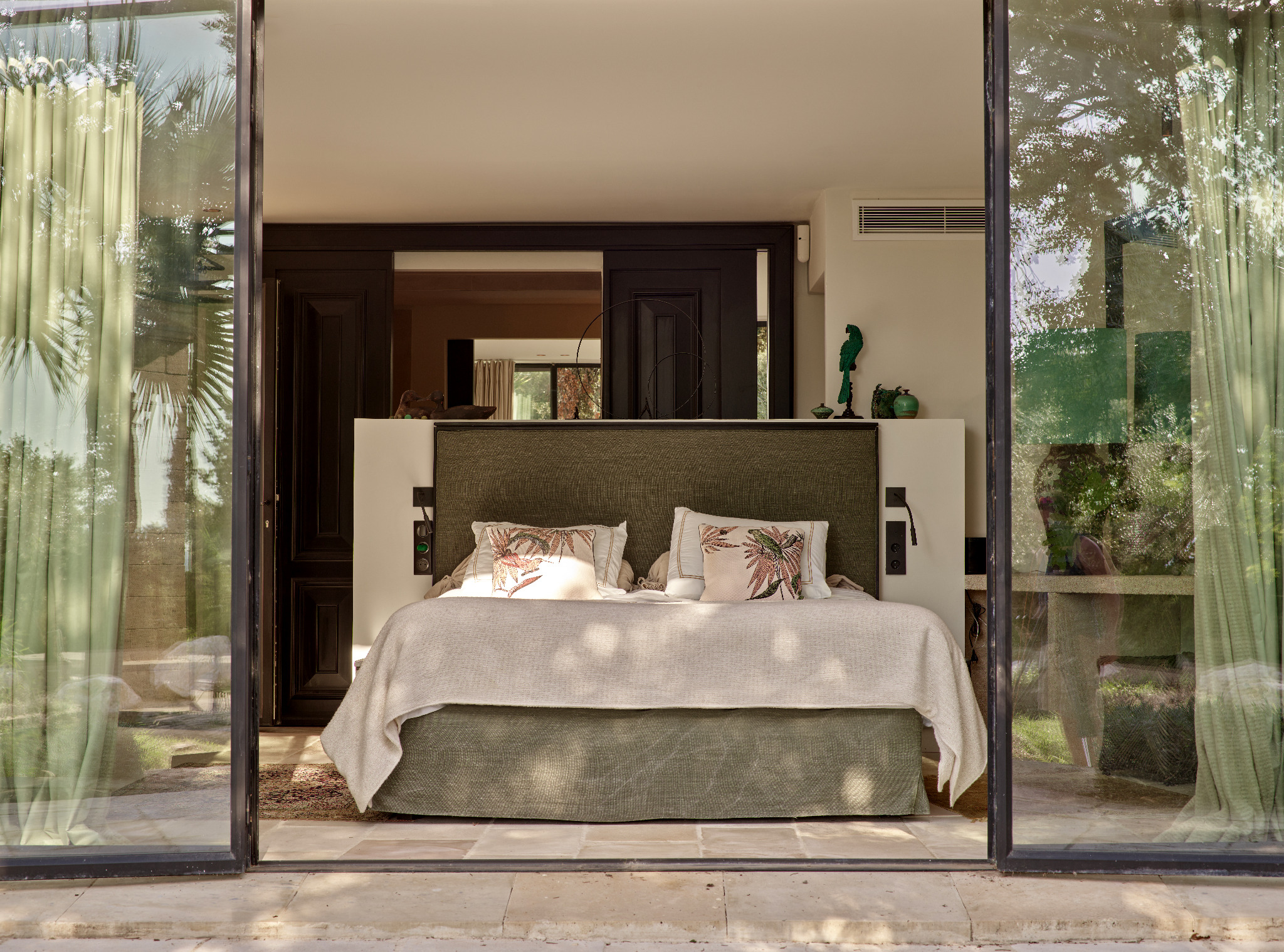 Bedroom with sitting area and floral cushions